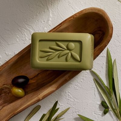 Thymes Olive Leaf Bar Soap with Moisturizing Bar Soap Formula flatlay on wooden tray